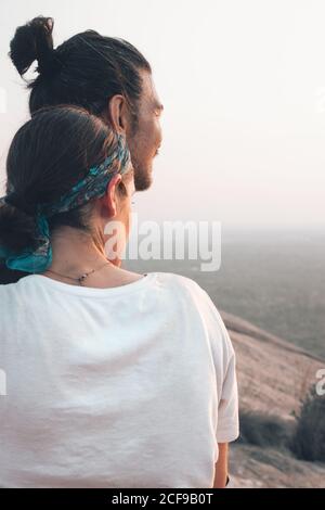 Content couple of hipsters in casual clothing hugging traveling together around Sri Lanka enjoying majestic landscapes