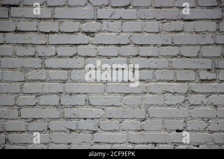 old grunge vintage brick wall painted into solid gray background texture Stock Photo