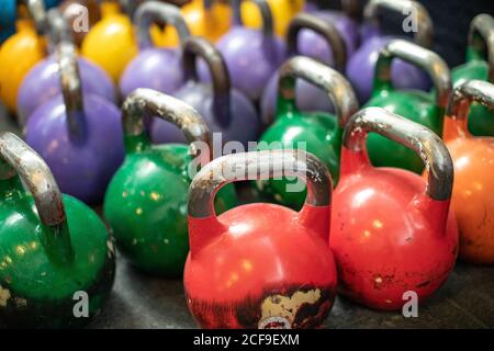 Shabby kettlebells on grass mat in gym Stock Photo