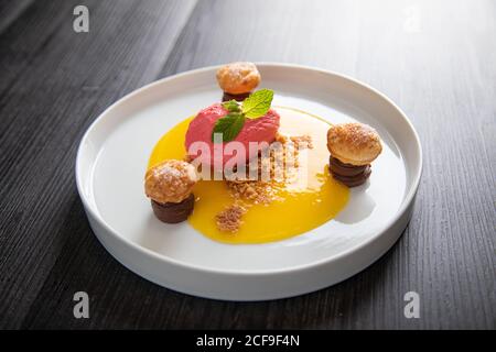 Raspberry ice cream with curable oranges chocolate and puff pastry Stock Photo