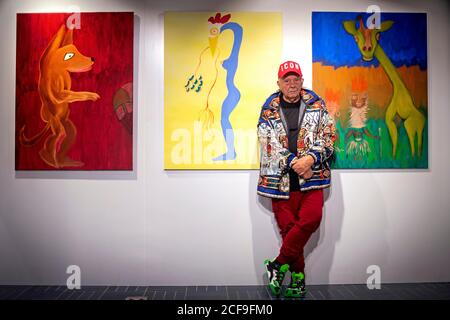 Fashion and portrait photographer David Bailey stands in front of three of his 50 unseen oil paintings that form part of his new exhibition which opens on September 7 at the W1 Curates Gallery, at Flannels, Oxford Street, London. Stock Photo