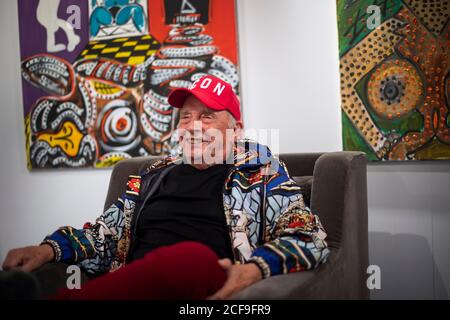 Fashion and portrait photographer David Bailey sits in front of some of his 50 unseen oil paintings that form part of his new exhibition which opens on September 7 at the W1 Curates Gallery, at Flannels, Oxford Street, London. Stock Photo