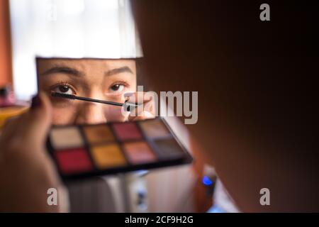Woman applying mascara on eyelashes Stock Photo