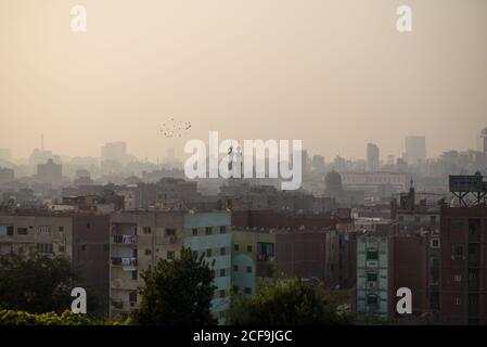 Amazing view of traditional city with building and ornamental minarets in misty morning day, Al-Azhar park, Cairo, Egypt Stock Photo