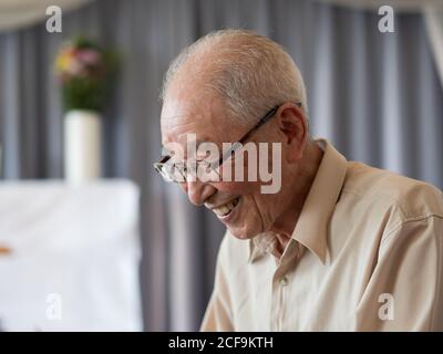 An old man talking animatedly at a family event Stock Photo