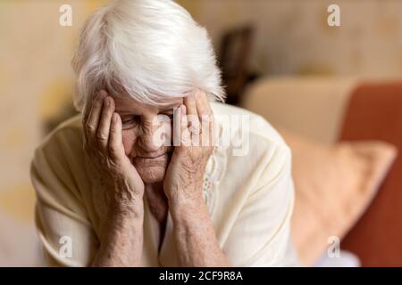 Portrait of an elderly woman in a state of worry at home Stock Photo