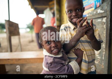 Uganda - November, 26 2016: Bald African children looking at camera while standing outside in a village Stock Photo