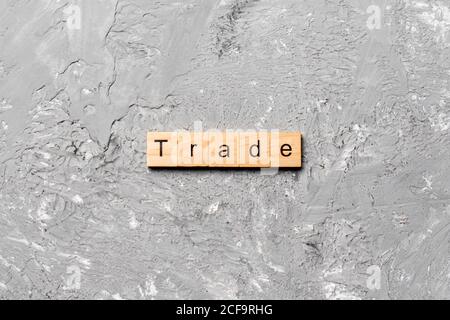 Trade word written on wood block. Trade text on cement table for your desing, concept. Stock Photo