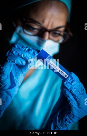 Conceptual image of a nurse holding a recipient with the coronavirus COVID-19 vaccine. Stock Photo