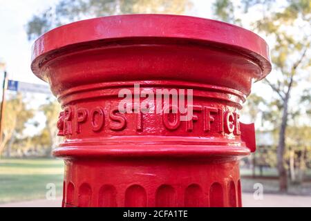 Post office mail box found in front of a telegraph station in Alice Springs, Australia. Metal letter box painted in red Stock Photo