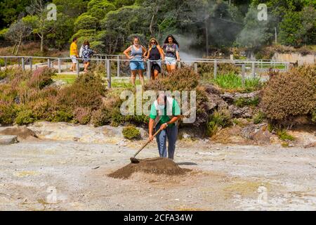 Furnas, Sao Miguel, Azores island, Portugal, August 14, 2020: people watch as worker take out Cozido, an Azores meal cooked in the ground near thermal Stock Photo