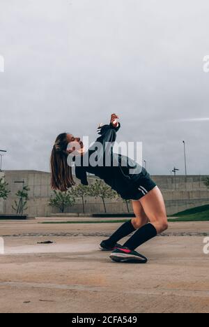 Female hip hop dancer in active wear striking pose outdoors Stock Photo