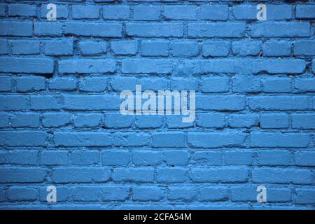 Old brick wall painted into solid blue. Beautiful grunge surface background Stock Photo