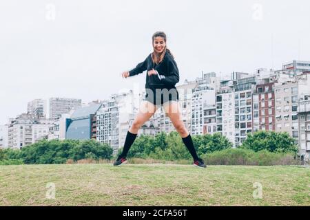 SportsWoman practicing yoga on lawn Stock Photo