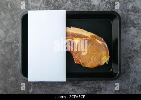 Raw beef steak t-bone in vacuum Packed, mockup for design idea. Top views, close-up Stock Photo