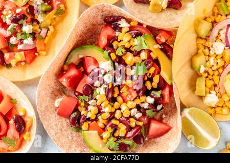 Vegetarian Mexican food, a flat lay. Tacos with vegetables, overhead close-up shot Stock Photo