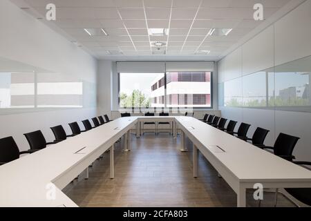 Interior of modern office with table and chairs located in room with white walls Stock Photo