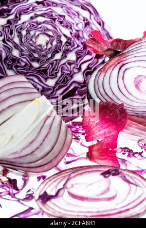 Fresh sliced red onions and red cabbage on white background Stock Photo