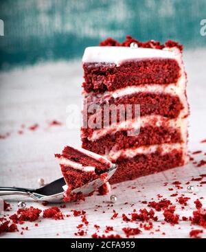 Slice of delicious red velvet cake on wooden table Stock Photo