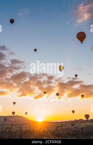 Bright hot air balloons flying over blue sea Stock Photo - Alamy