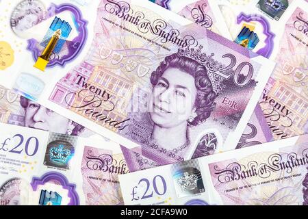 Scattered new 20 pound polymer notes with British monarch Queen Elizabeth II Stock Photo