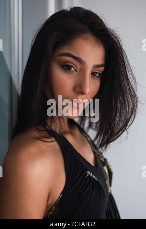 Side view beautiful passionate brunette Hispanic Woman in black wear Stock Photo