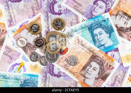 New British pound polymer notes and coins scattered Stock Photo