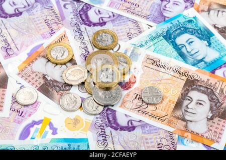 New British pound polymer notes and coins scattered Stock Photo