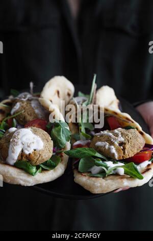 Falafel and fresh vegetables in pita bread on plate for eating vegetarian healthy food Stock Photo