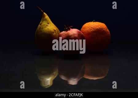 Closeup shot of stale fruits on a reflective surface Stock Photo