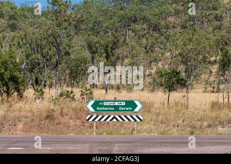 Indication panel on the road showing opposite directions: Katherine, Darwin. Green billboard with arrows. Stuart highway crossing the Australian outba Stock Photo