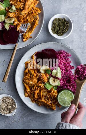 Plates with red quinoa and chicken curry Stock Photo