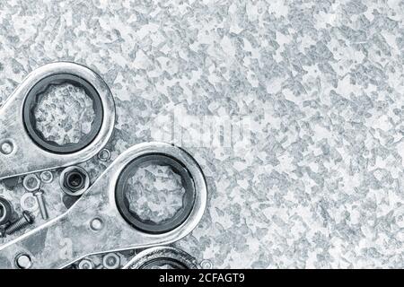 Wrench tools ratchets on a light metallic textured background Stock Photo
