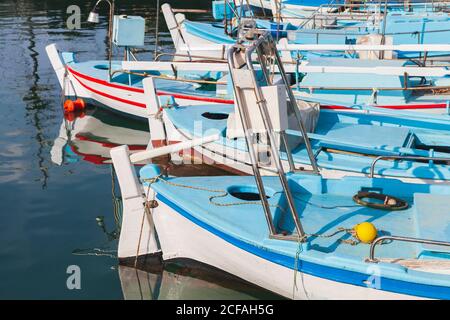 Traditional Greek white blue wooden fishing boats are moored in Ayia Napa port, Cyprus Stock Photo