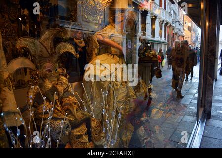 Venice, Italy 02 12 2017: tourists in front of venetian shop during carnival masquerade Stock Photo