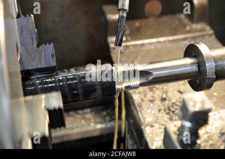 Metalworking machine at work. Lubricating and cooling fluid Stock Photo