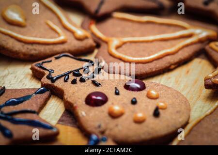 Closeup on children hand decorated christmas gingerbread cookie snowman figurine Stock Photo