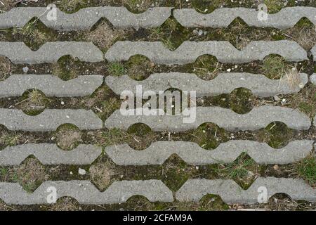 stone pavement pattern with grass, moss and rocks inbetween Stock Photo