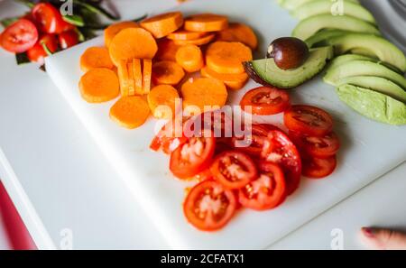 Assorted ripe cut vegetables for cooking healthy salad in kitchen Stock Photo