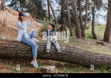 boy looking at mother in VR headset Stock Photo