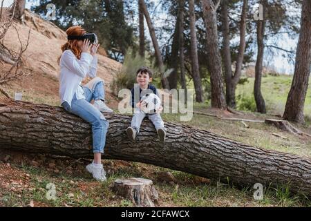 boy looking at mother in VR headset Stock Photo