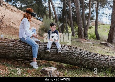 boy looking at mother in VR headset Stock Photo