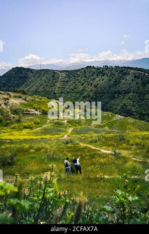 Group of friends walking on a path on a sunny day while sightseeing in Granada In Spain Stock Photo