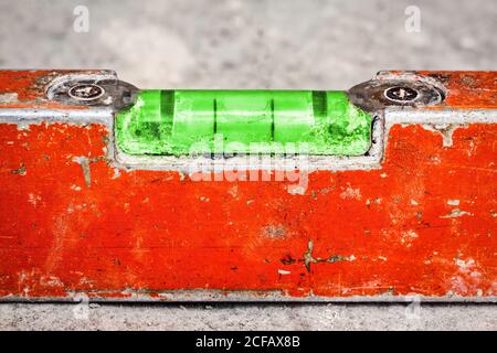 Macro image of a used and dirty spirit level on a concrete wall Stock Photo