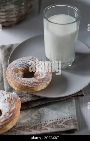 Tasty cookies oatmeal with raisins and chocolate and glass of milk on rustic wooden background Stock Photo