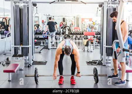 Adult muscular athlete doing exercise in gym Stock Photo