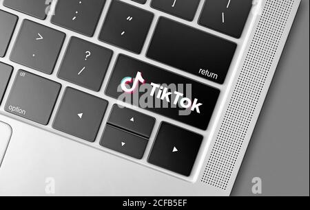 Tik Tok social networking service key on computer keyboard, modern technologies concept with Tik Tok logo Stock Photo