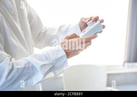 Assistant working in lab with pink liquid Stock Photo