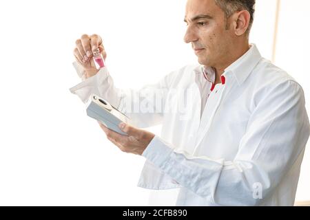 Assistant working in lab with pink liquid Stock Photo