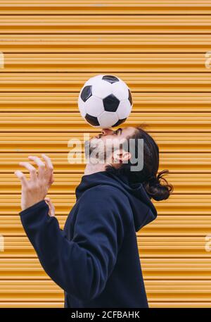 man playing soccer ball with head Stock Photo